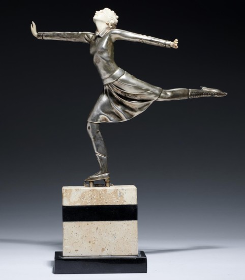 AN ART DECO SILVERED METAL AND IMITATION IVORY STATUETTE OF ...