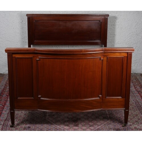 AN EDWARDIAN MAHOGANY BED the panelled headboard with confor...