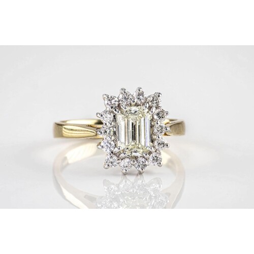 An 18ct gold and emerald cut diamond cluster ring, the centr...