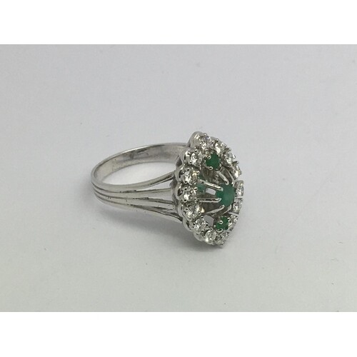 An 18ct white gold, diamond and emerald marquis shape cluste...