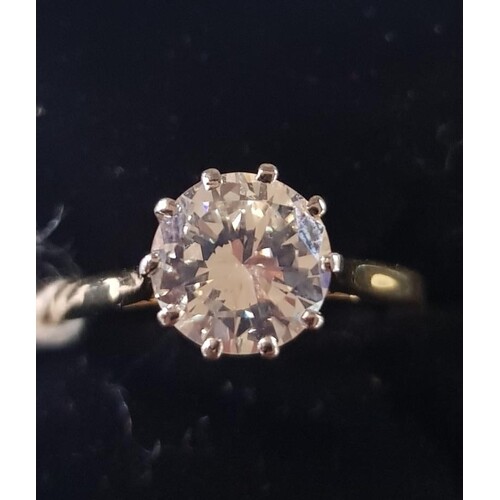 An 18ct yellow and white gold diamond solitaire ring, approx...