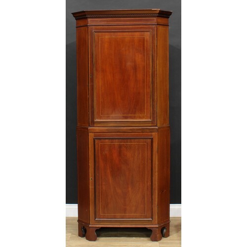 An Edwardian mahogany floor-standing corner cabinet, outswep...