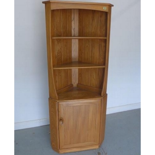 An Ercol elm corner cabinet with a single door - Height 160c...