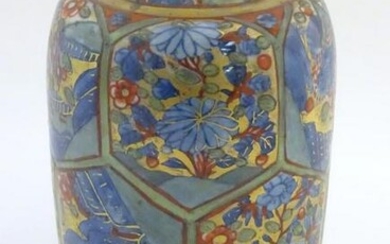 An Oriental vase with hexagonal panelling depicting