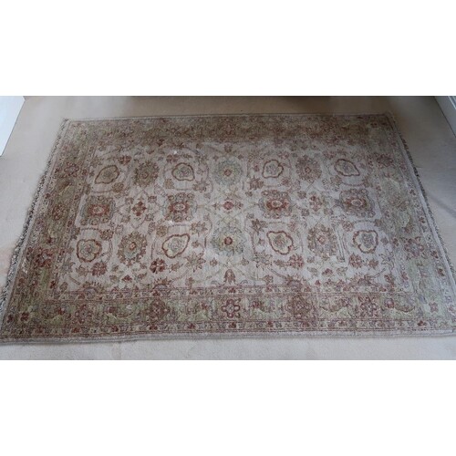 An Oriental wool rug, the pale ground with lilac and rust mo...