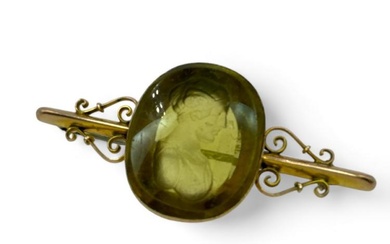An antique glass intaglio in a "9c" stamped brooch mount....