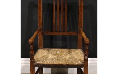 An early 19th century beech and ash child’s elbow chair, tur...