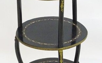 An early 19thC ebonised etagere with a plate to the