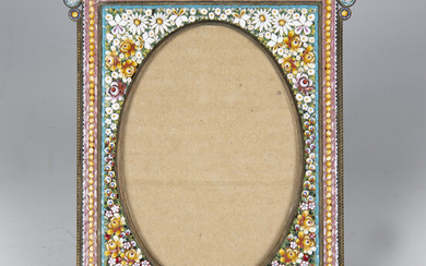 An early 20th century Italian micro-mosaic photograph frame, the oval aperture within a surround of