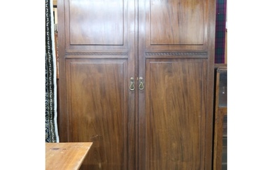 An early 20th century mahogany compactum wardrobe with pair ...
