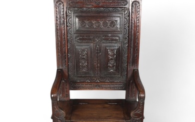 Antique carved and panelled oak hall settle, with rising sea...