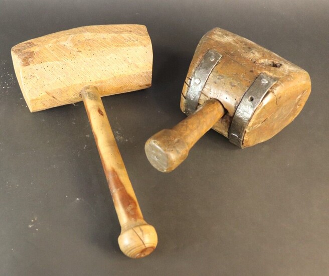Two wooden carver's mallets. Arc-shaped mallet with slanting strokes
