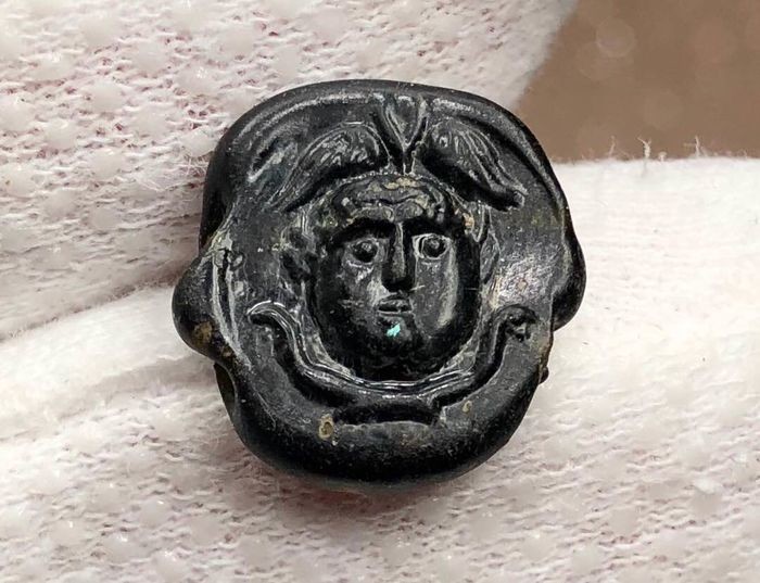 Excellent Ancient RomanGlass Central Bead with an image of Medusa (Gorgona) wearing a wigned had,two snakes below.