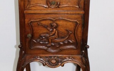 French Louis XV style carved walnut chevet with cherub