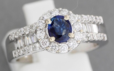 Gold ring centered with a sapphire adorned with lines of...
