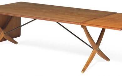 Hans J. Wegner: “AT 314”. A teak dining table with fold down leaves, mounted on oak frame with cross legs and brass stretchers. Made by Andreas Tuck.