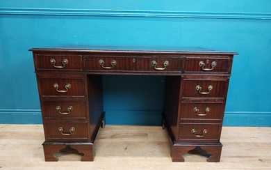 Mahogany pedestal desk with tooled leather top and eight sho...