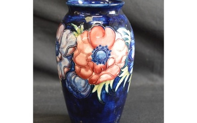Moorcroft pottery vase in the Anemone pattern on blue ground...