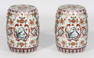 PAIR OF JAPANESE PORCELAIN GARDEN SEATS With green and red chrysanthemum and flower designs on a white ground. Heights 19". Diameter...
