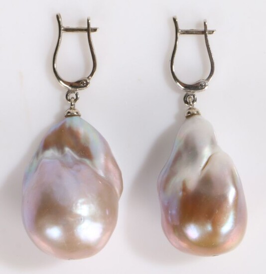 Pair of 14 carat white gold and pearl earrings, the gold loops above the large pearls, the pearls