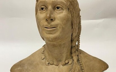 Patinated terracotta sculpture showing a bust of an Indian woman.