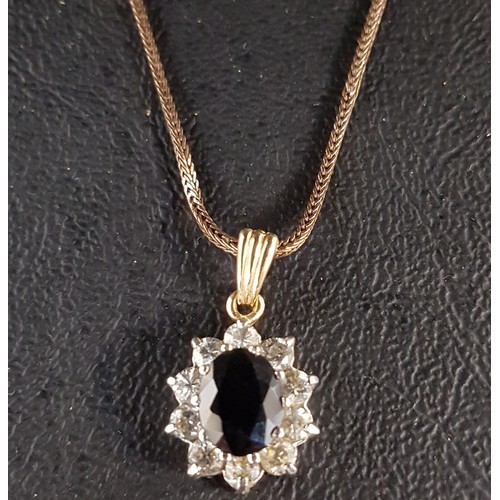 SAPPHIRE AND CZ CLUSTER PENDANT in nine carat gold, the cent...