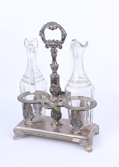 Silver oil and vinegar cruet with shells, palmettes and foliage decoration. The monogrammed VD base.