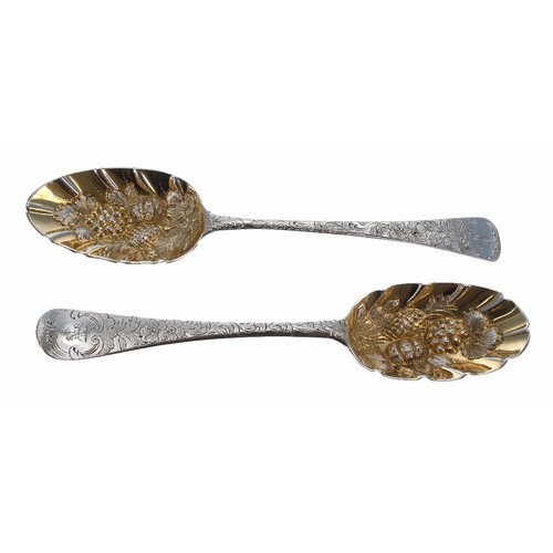 Two similar Georgian silver serving spoons, with gilt emboss...