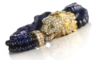 Van Cleef & Arpels: A sapphire and diamond bracelet in the shape of a lion's head with sapphire beads, emeralds and diamonds, mounted in 18k gold. F-G/VVS-VS