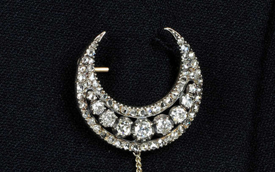 An early 19th century silver and gold, old and rose-cut diamond crescent brooch.