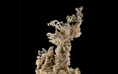 An ivory group of dancers amongst clouds and flowering branches, wood base (slight defects) China, early 20th century (h. 46...