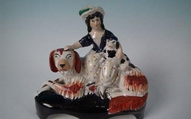 Staffordshire girl on spaniel with puppy figure