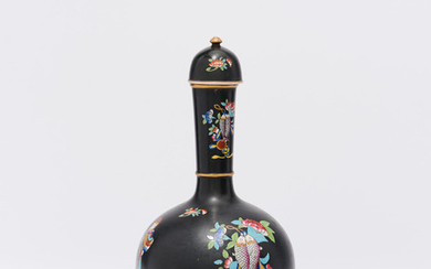 A black-glazed bottle with a cap and stand