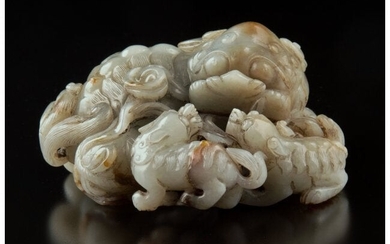 28024: A Chinese Carved Celadon and Russet Jade Lion Fi