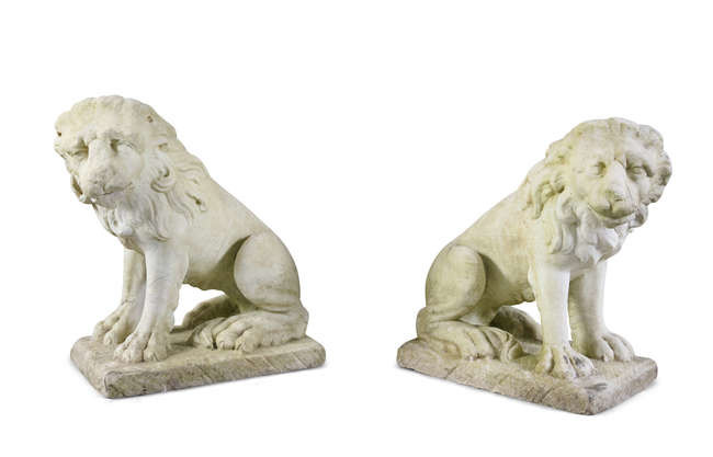 A PAIR OF CARVED MARBLE LIONS, seated, on...