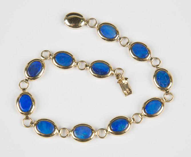 A 14ct gold and blue opal doublet oval link bracelet on an oval gold clasp, weight 7.2g, length 18.5