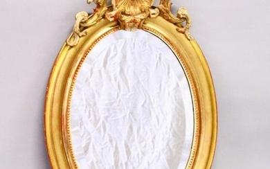 A 19TH CENTURY GILT FRAMED OVAL WALL MIRROR, with shell