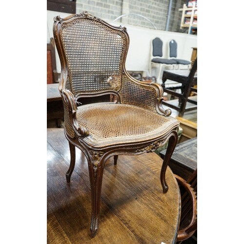 A 19th century French carved and caned walnut salon chair, w...