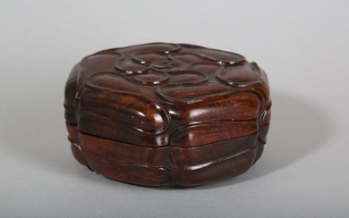 A CHINESE ROSEWOOD HEXAGONAL BOX AND COVER. Qing Dynasty. Polished and carved with stylised petals to the cover and base, 12.5cm diameter. (2) Provenance: English private collection, acquired in China in the early 20th Century, thence by descent. 清...