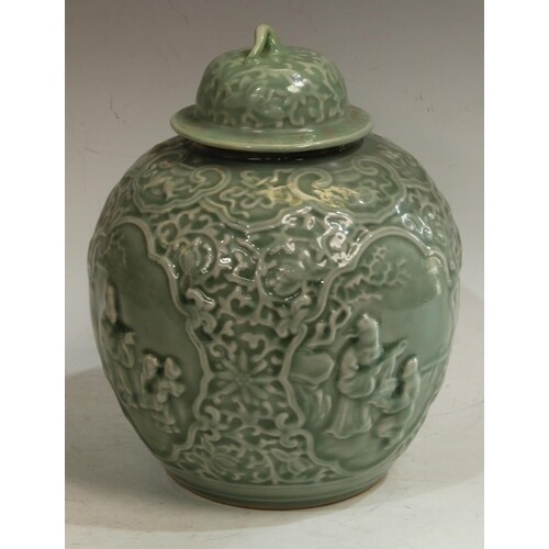 A Chinese celadon ovoid wine jar and cover, moulded in relie...