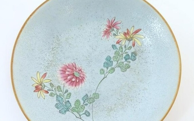 A Chinese plate with stylised peony flower detail.