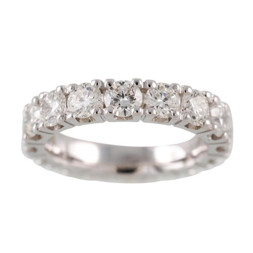 A DIAMOND ETERNITY RING, the brilliant cut diamonds mounted ...