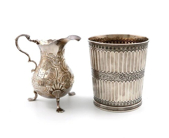 A George II silver cream jug, maker~s mark W?, London 1744, baluster form, embossed with animals and village scenes, on three hoof feet, height 9cm, plus a William IV silver beaker, London 1835, with later fluted decoration, height 8.6cm, approx...