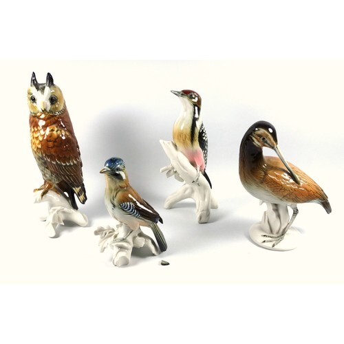 A Karl Ens porcelain figure of a woodpecker perched upon a t...