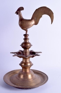 A LARGE INDIAN BRONZE LAMP together with a large wooden