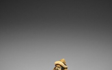 A RARE AND EARLY IVORY NETSUKE OF A SEATED DUTCHMAN READING