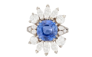 A SAPPHIRE AND DIAMOND CLUSTER RING The cushion-shaped sapp...