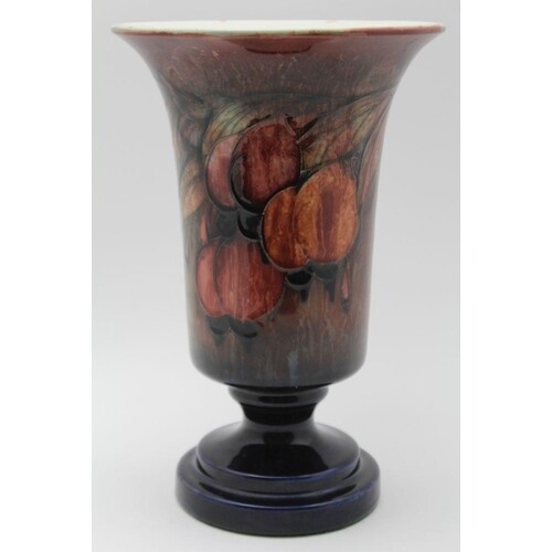 A WILLIAM MOORCROFT POTTERY VASE with flared rim on circular...
