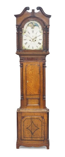 A Welsh oak longcase clock, by D. Herbert, Aberystwyth, circa 1830, the hood with broken swan neck pediment above wrythen turned pilasters, the waist with ogee pointed arch door with bone escutcheon, fluted corbels and pillars on an arched panelled...