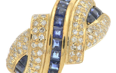 A brilliant-cut diamond and sapphire crossover ring.